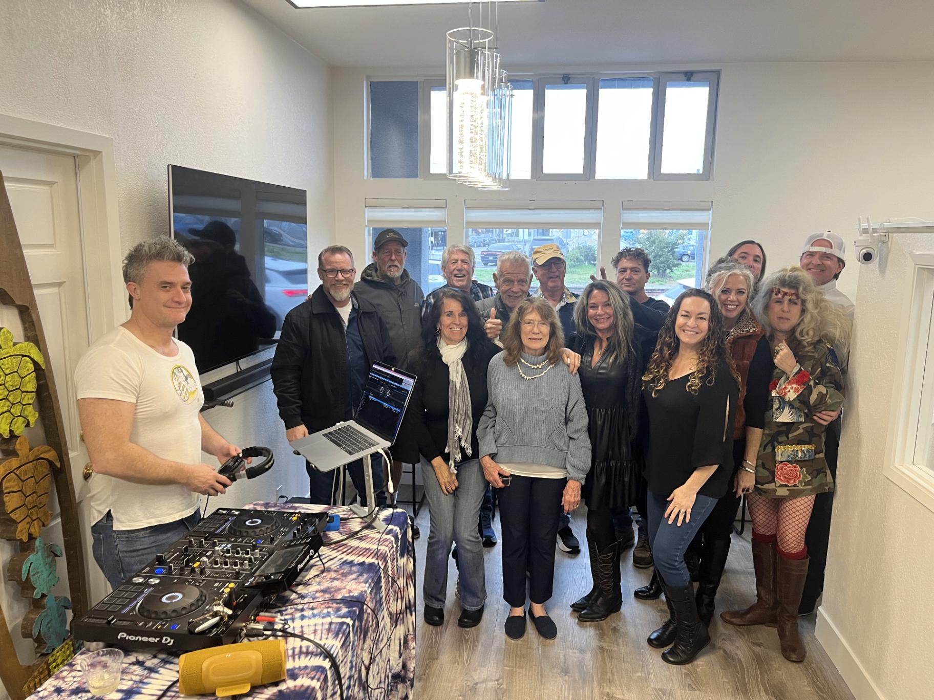 On The Bay office — community gathering with DJ setup